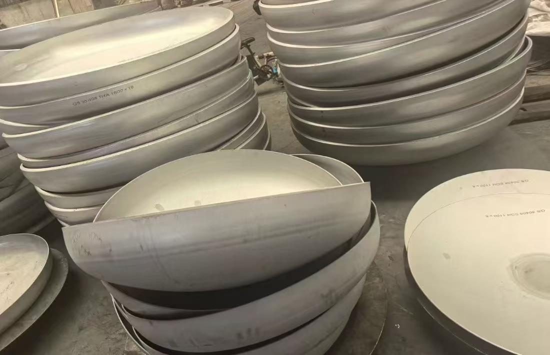 Torispherical dished heads stacked for storage